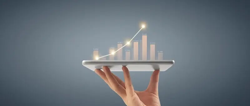 bar chart floating over a tablet