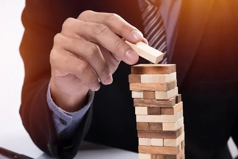 businessman playing jenga