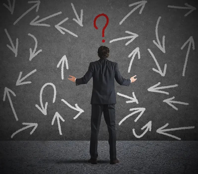 man confused by choices represneted by arrows pointing in many directions