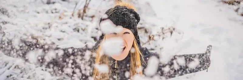woman playing in snow